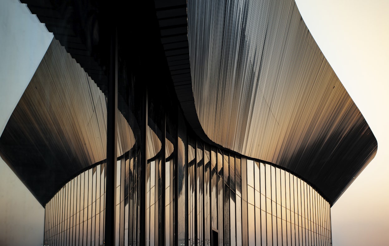 Metallic roof of the Polestar Production Centre in Chengdu, China with the afternoon sky in the background.