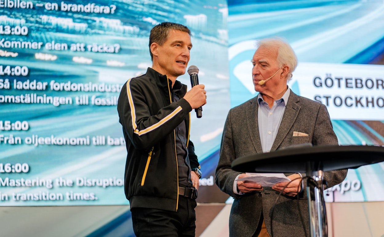 Thomas Ingenlath holding a microphone on stage at Ecar expo 2019.