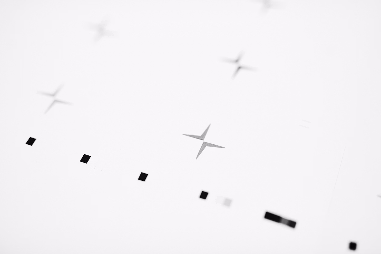 Black dots and the Polestar logo on a white background