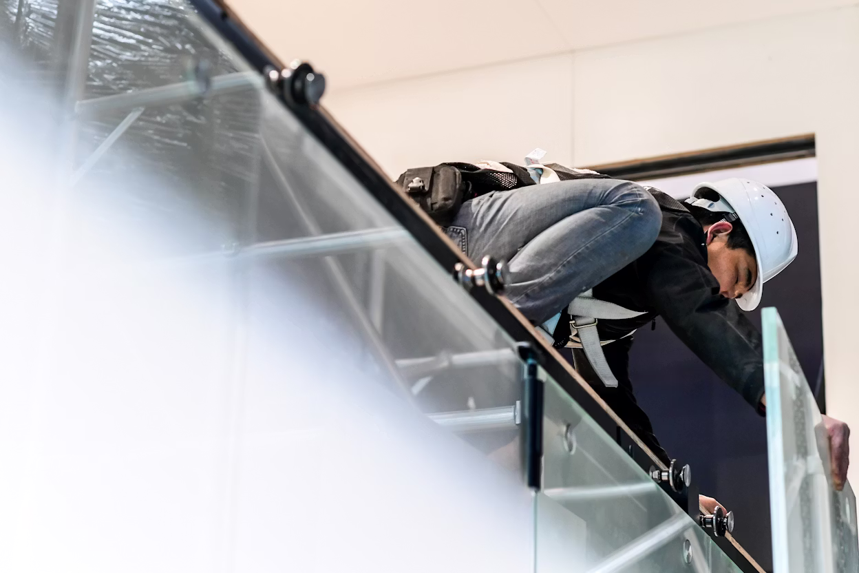 Builder wearing a helmet building the Polestar display stand.