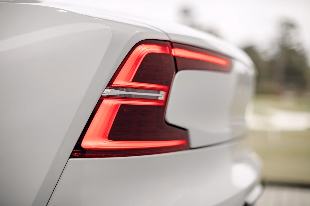 Red-lit tail light on a white Polestar 1.