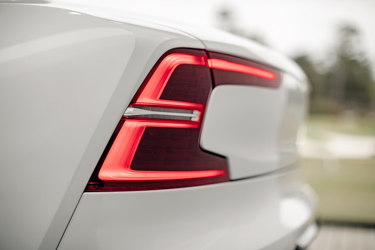 Red-lit tail light on a white Polestar 1.