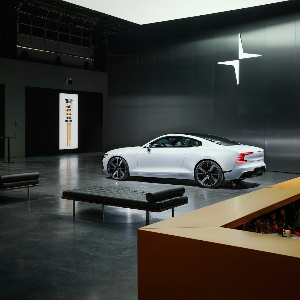 A white Polestar 1 displayed in a dark, minimalistic Polestar space.