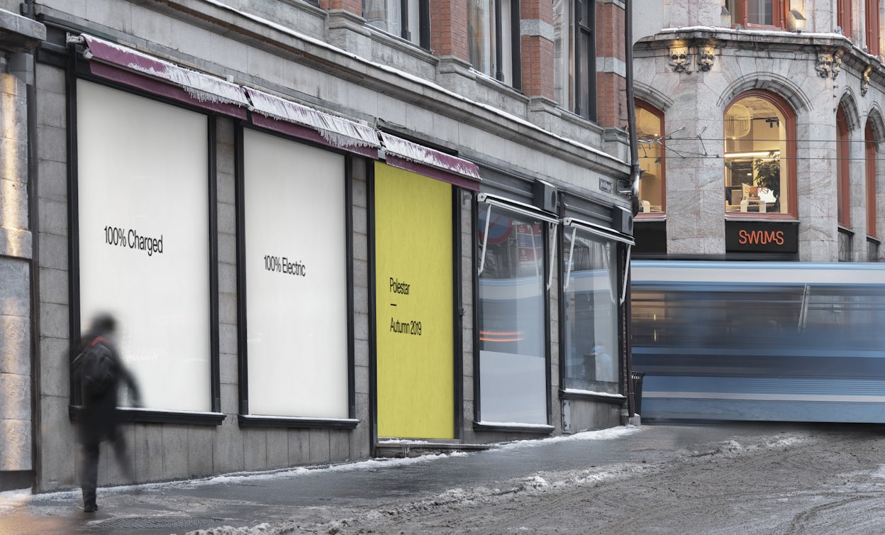 A snowy street with billboards that reads 100% charged 100% Electric Polestar Autumn 2019.