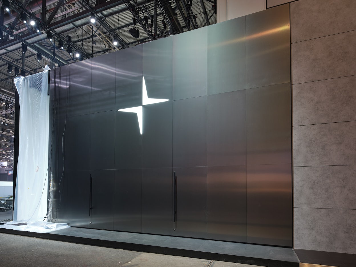 The Polestar logo on a shiny metallic wall.