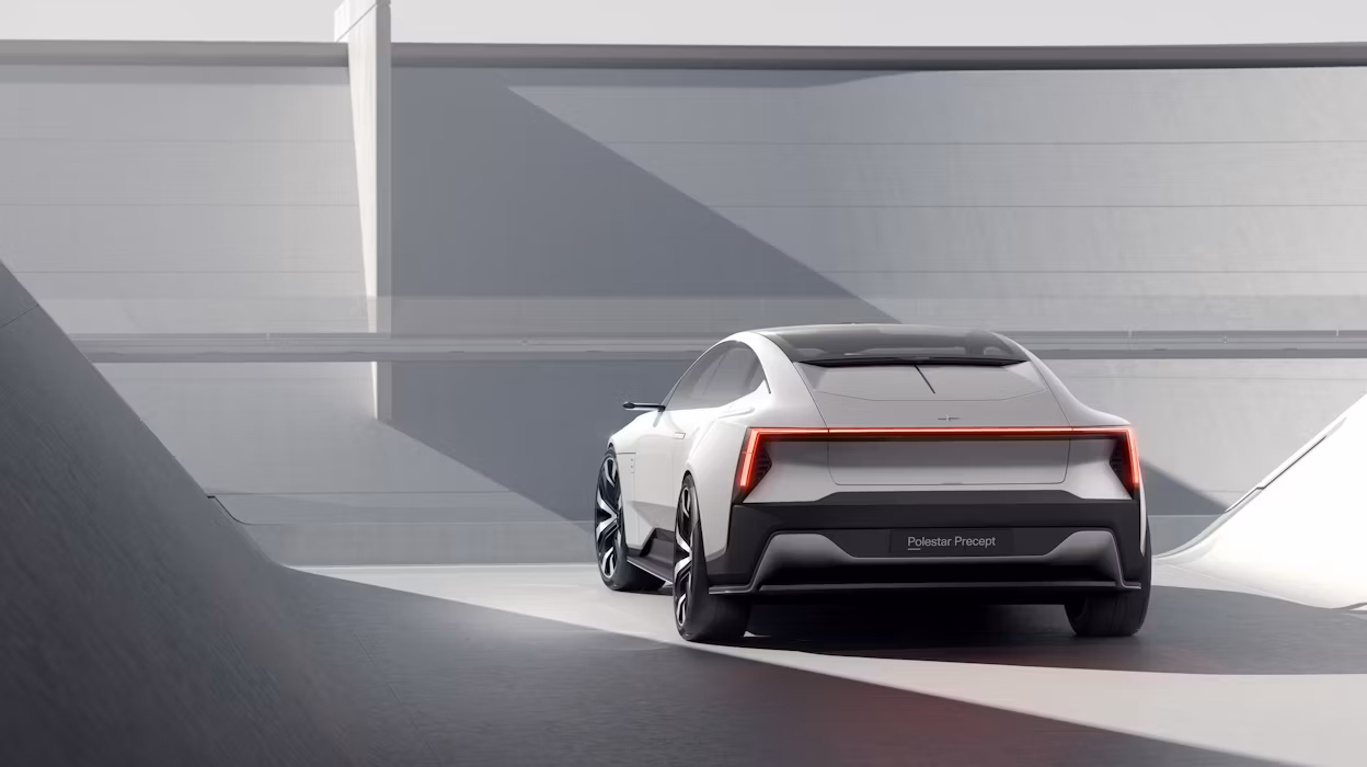 Back view of a grey Polestar Precept parked in a grey shaded space.