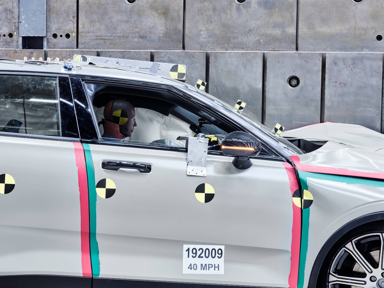 A crash test dummy behind the wheel in a Polestar 2.