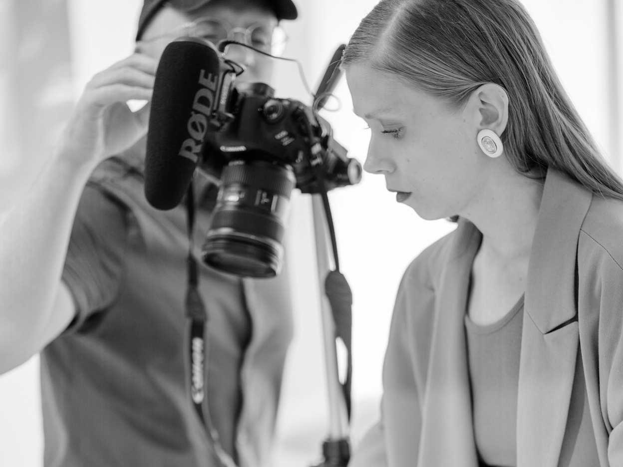 Jenny Mustard and a photographer photographed in black and white.