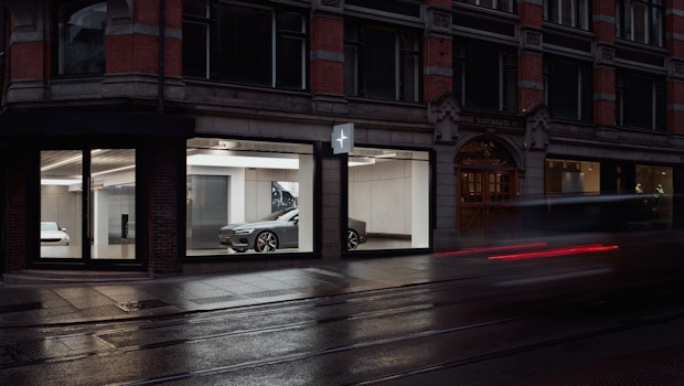 A street corner with a Polestar visible through large windows