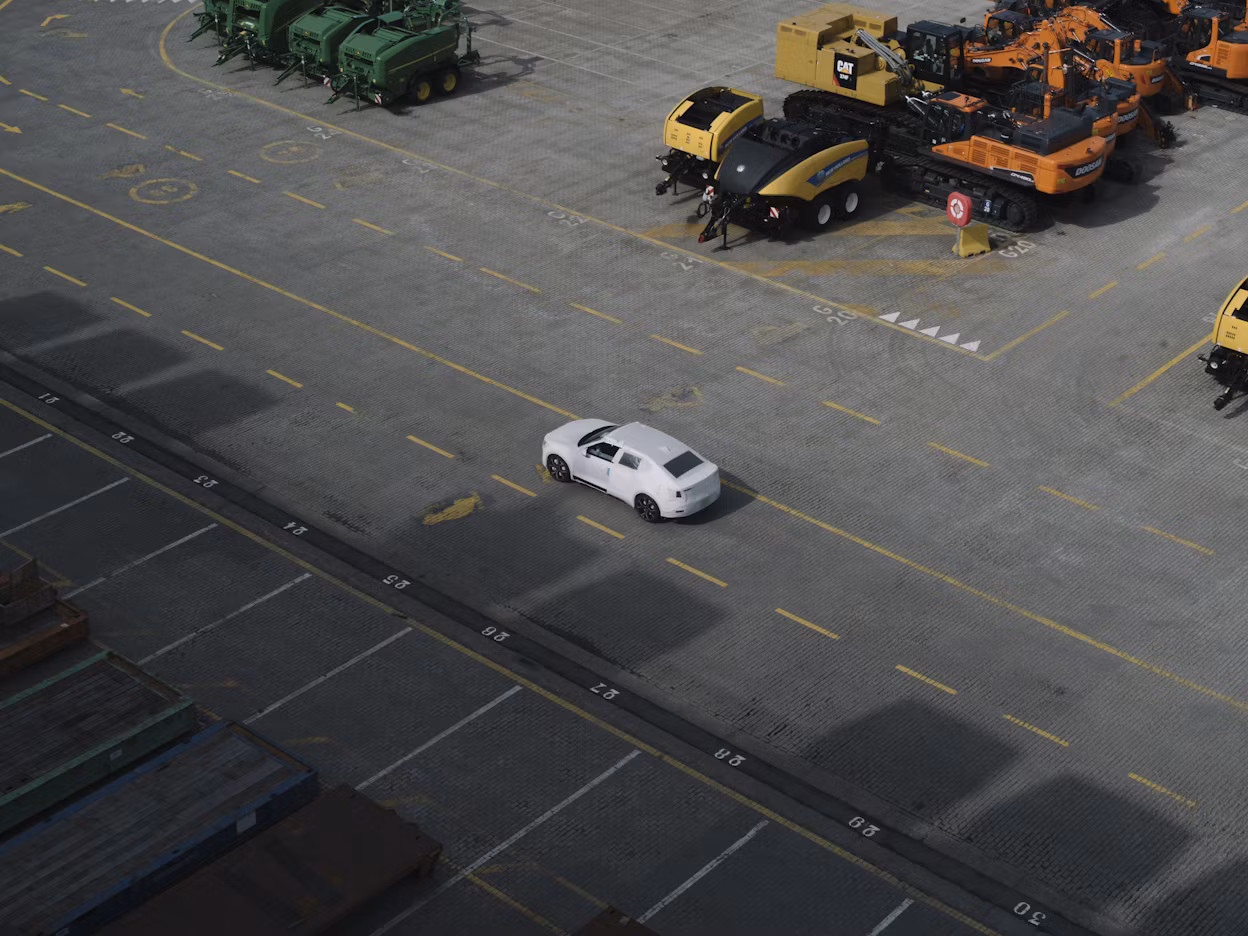 A Polestar viewed from above at an industrial port.