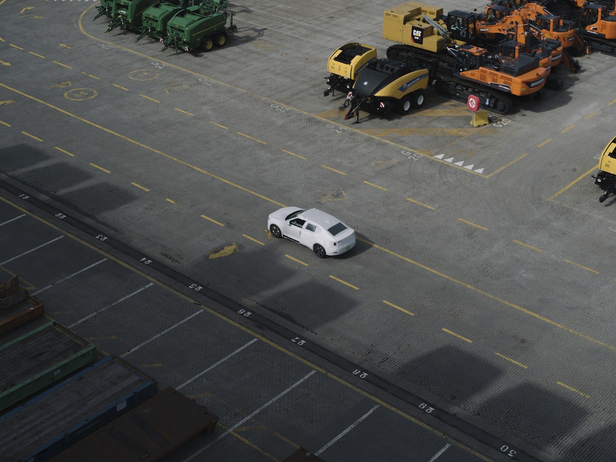 A Polestar viewed from above at an industrial port.