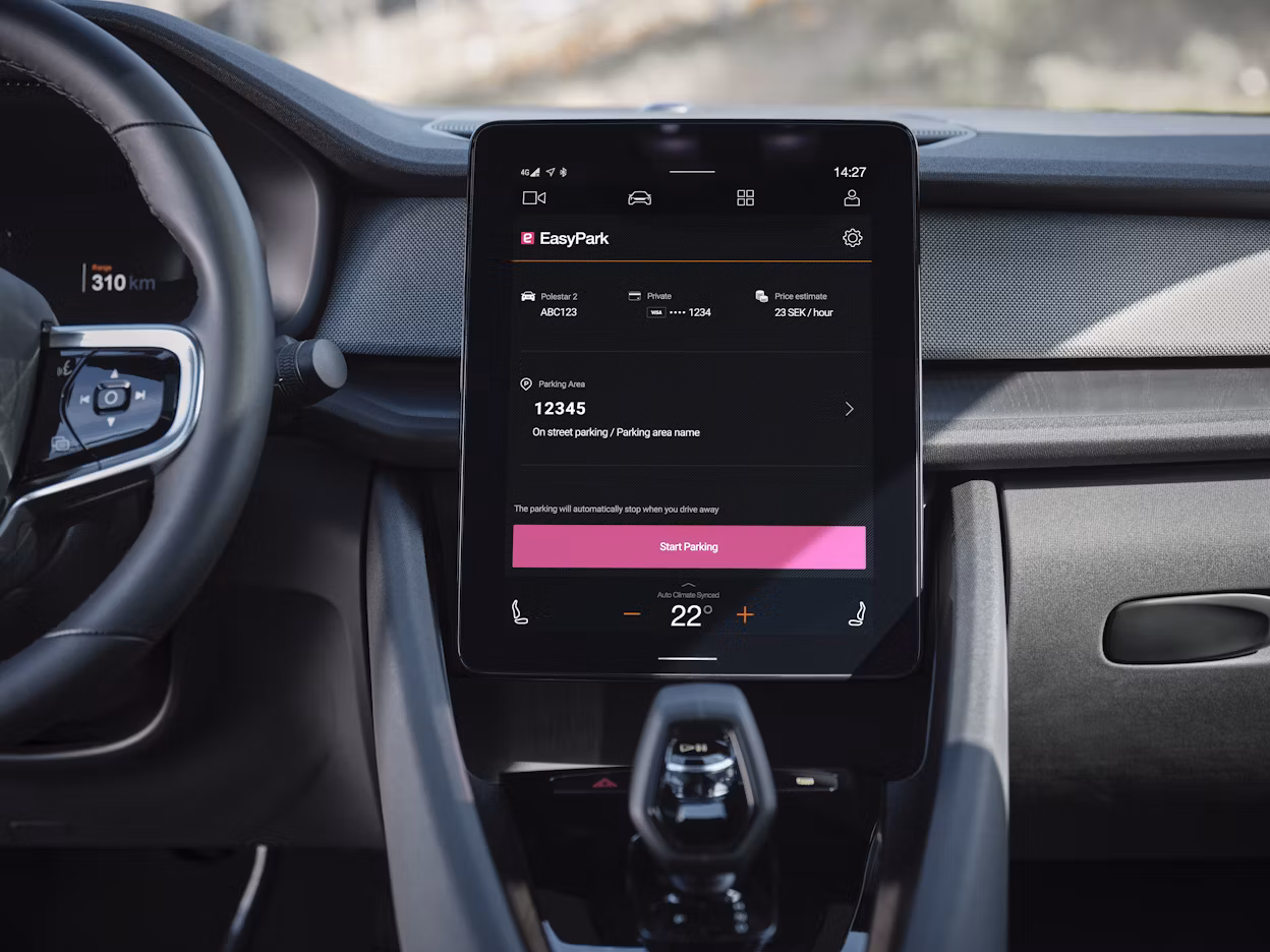 Dashboard of a Polestar car displaying EasyPark app on a central touchscreen with parking and climate control options.