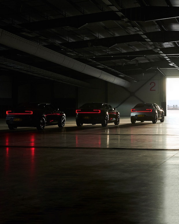 Three Polestar 2 cars driving out from a industrial place