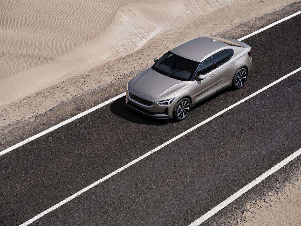 Bird's-eye view of a Polestar 2 driving on a desert road.