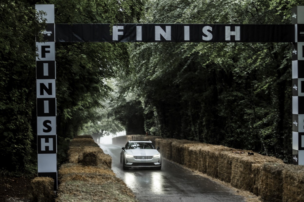 A white Polestar 2 about to hit the finish line at the Goodwood Festival of Speed.