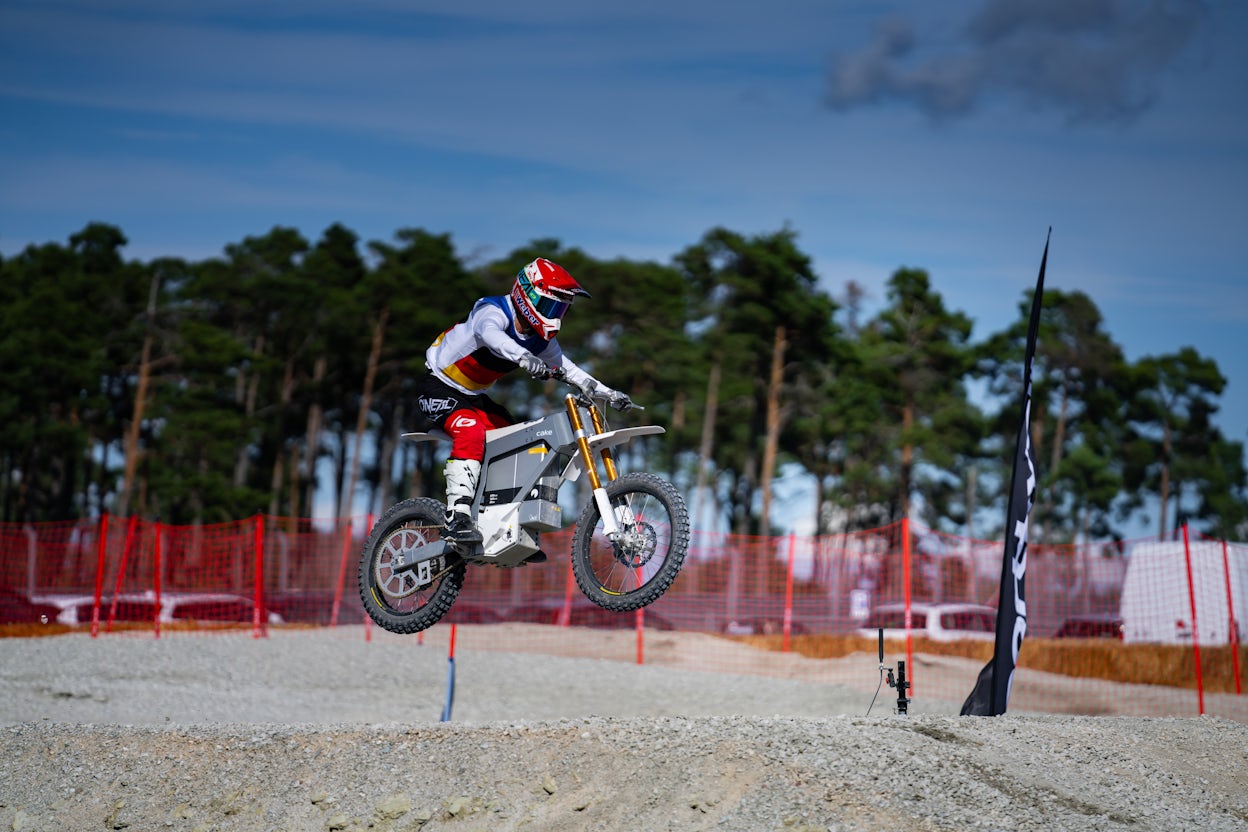 Cake bike contestant soaring through the air on a jump.