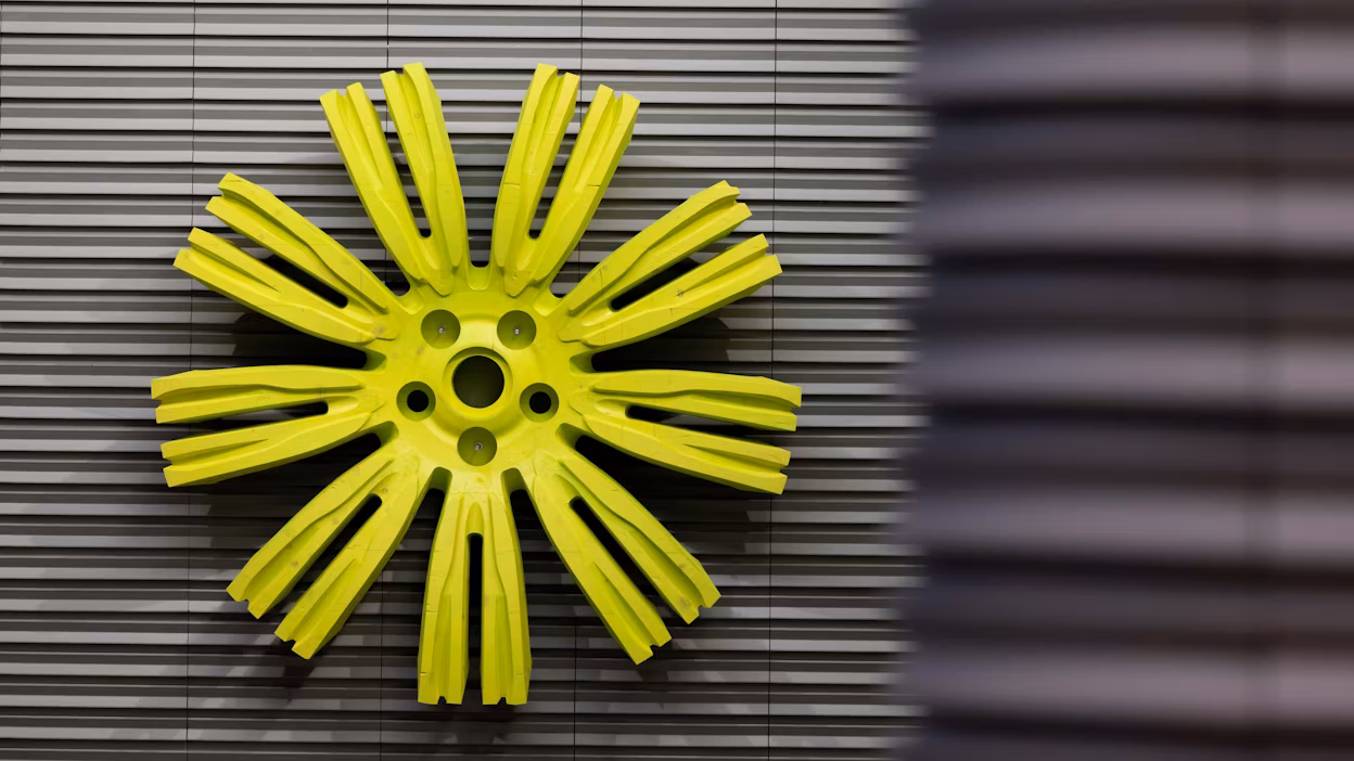 Art piece resembling a lime green round rim on a metallic background.