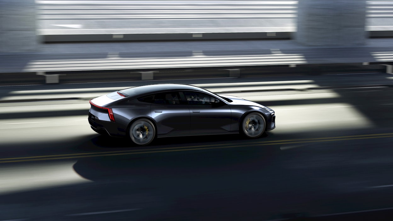 Shiny Polestar 5 driving on the road with blurry background.