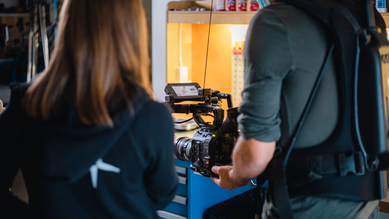 Cameraman filming behind the scenes at Öhlins headquarters.