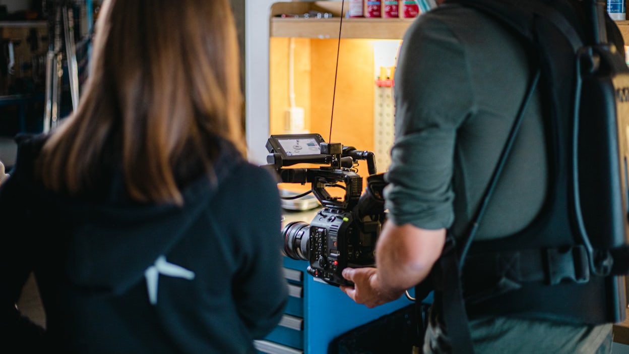 Cameraman filming behind the scenes at Öhlins headquarters.