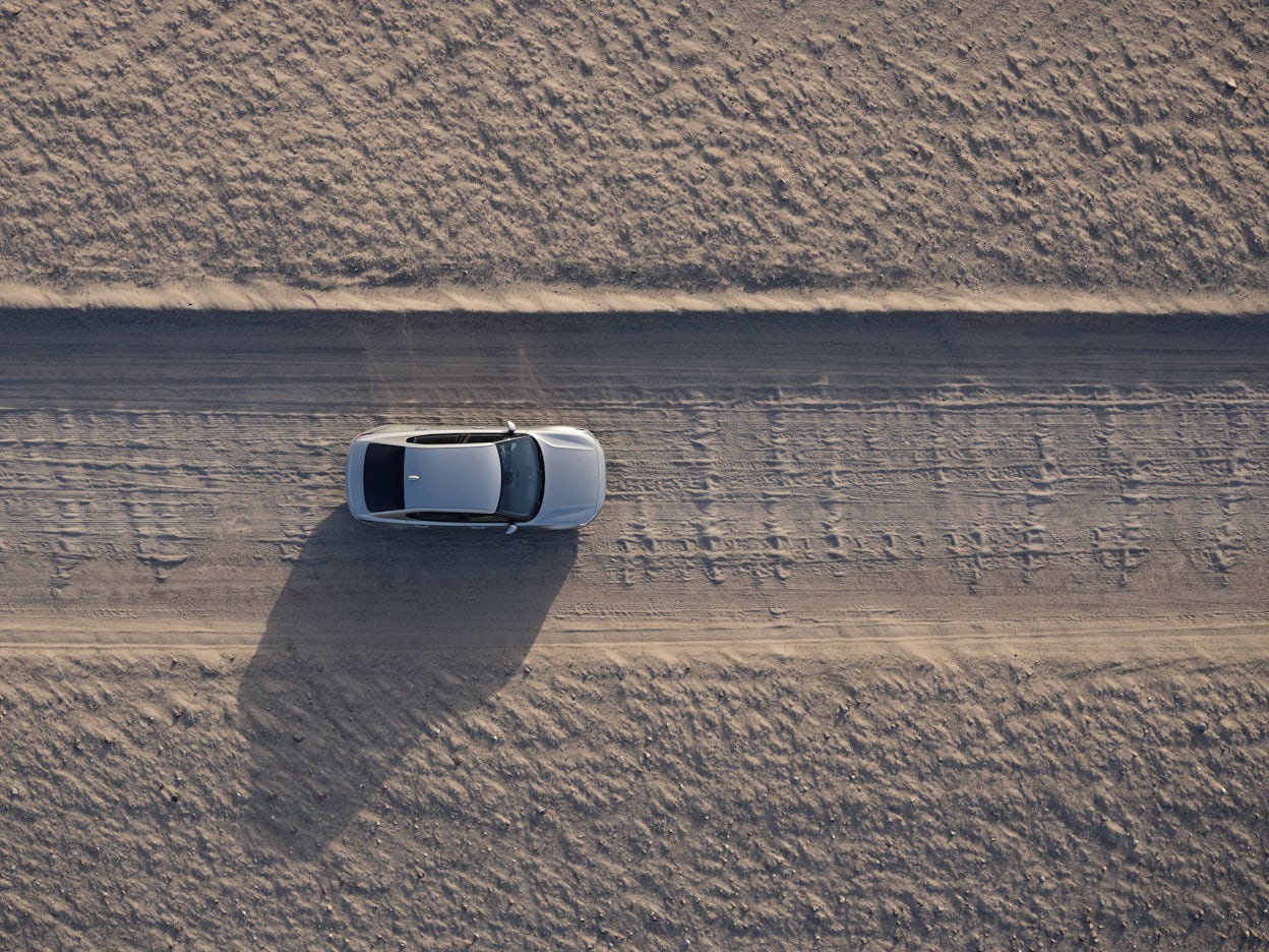 Bird's-eye view of Polestar 2 driving in desert landscape 