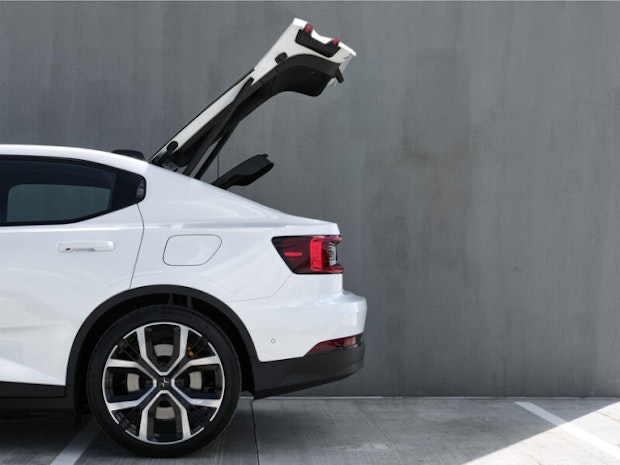 The rear part of a white Polestar 2 with boot lid open