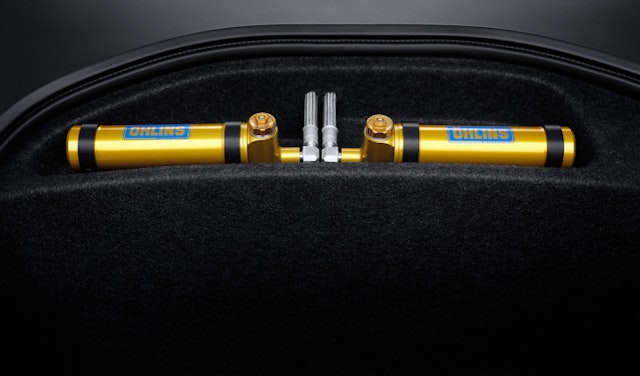 Golden adjustable Öhlins dampers in compartment