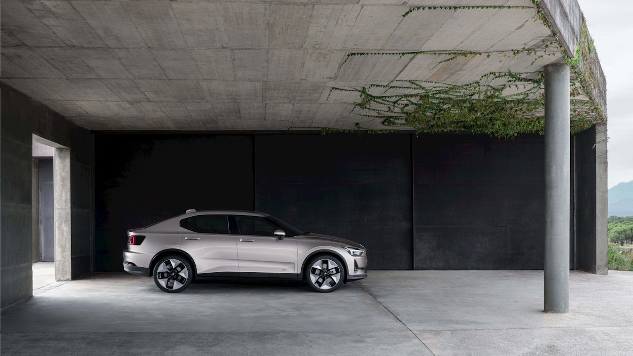 Polestar 2 parked beneath a bridge.