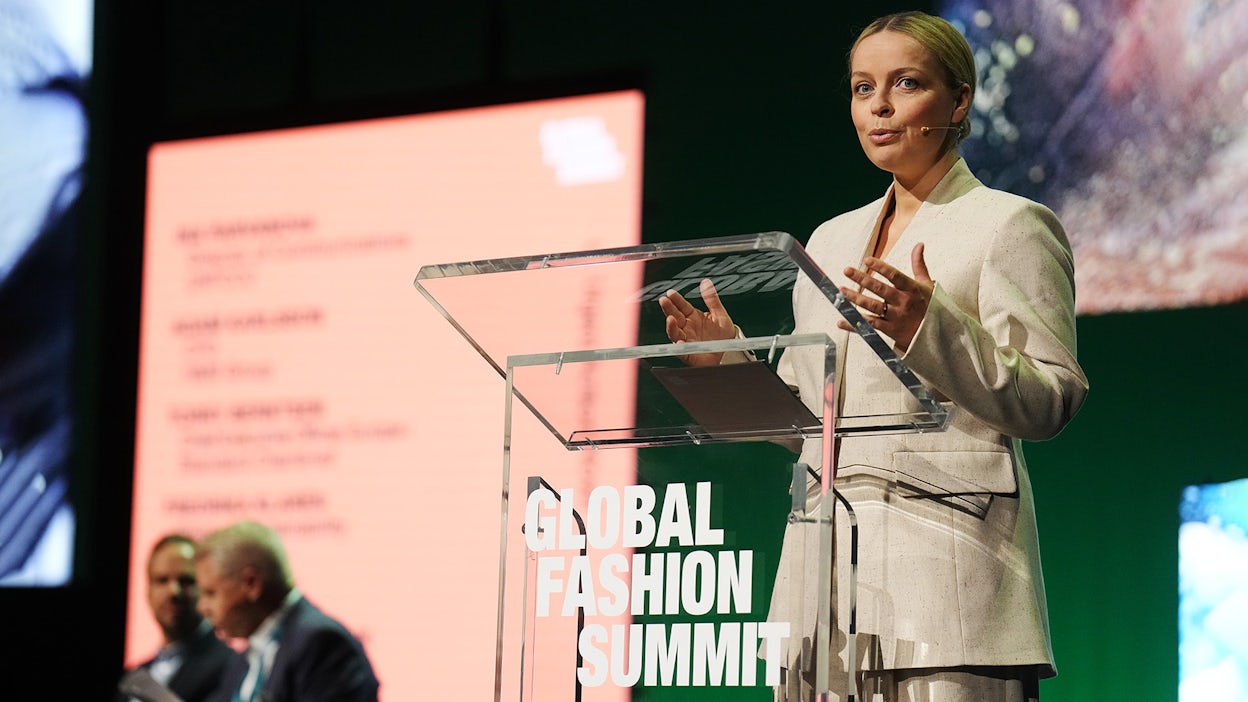Fredrika Klarén speaking by the podium at the Global Fashion Summit.