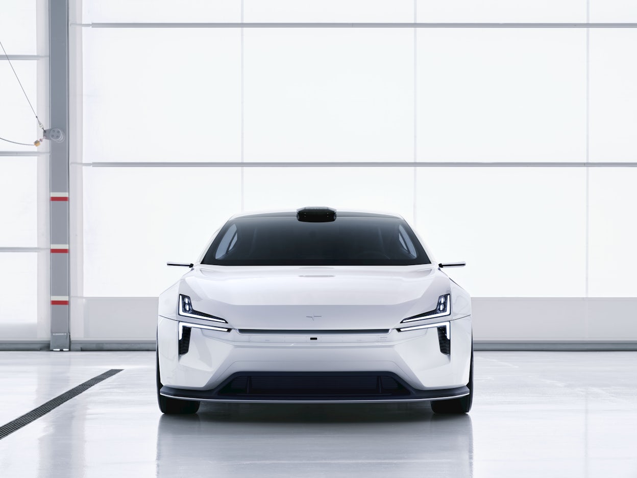 A white Polestar 5 in a studio.