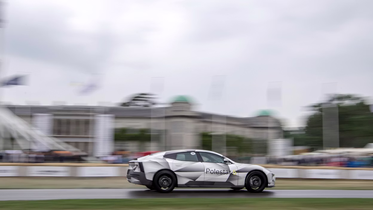 Polestar 5 racing at Goodwood hillclimb, with a blurry background.