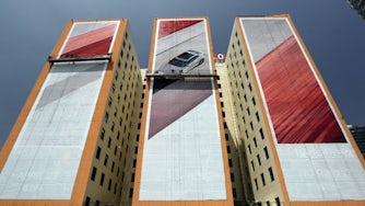 Hand-painted Polestar 2 poster on a building.