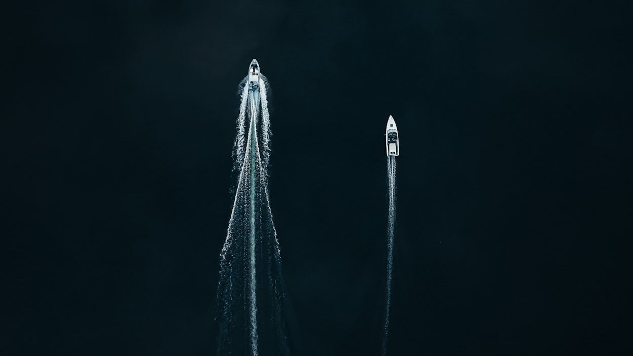 Two boats on the water, as seen from above.