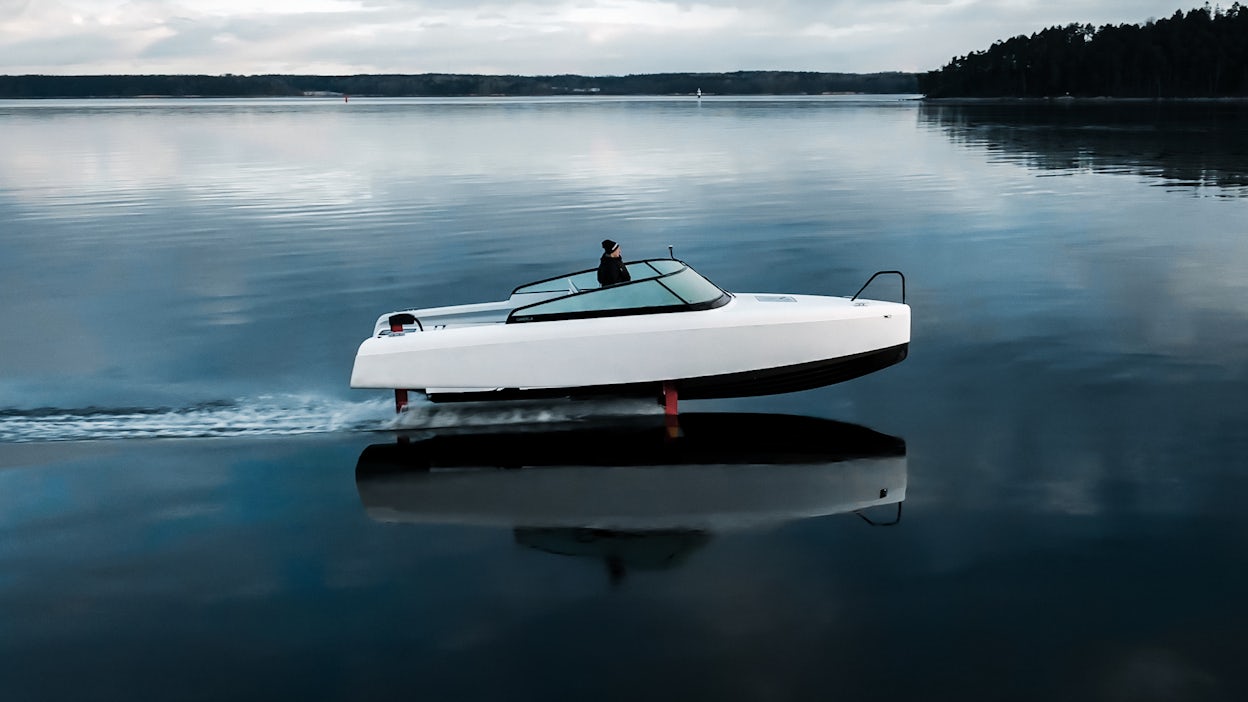 A white boat on the water, as seen from the side.