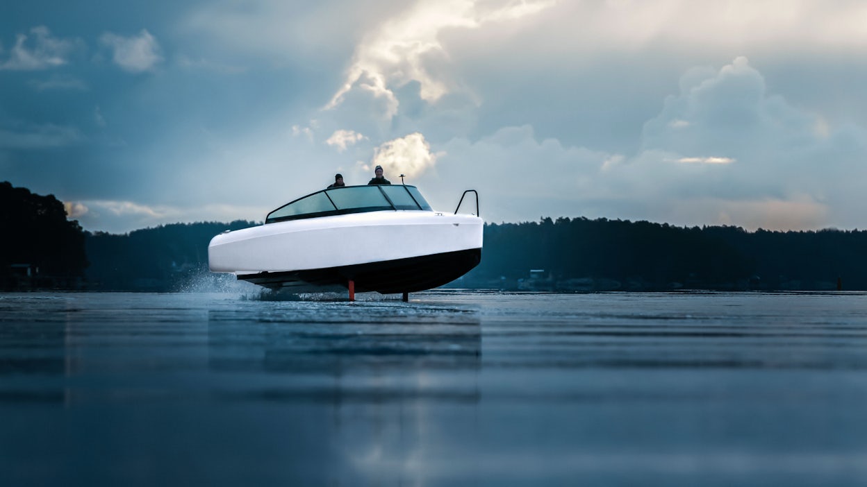 A white boat on the water, seen from the front.