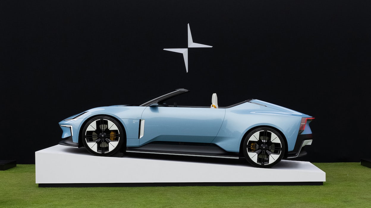 Side view of a light blue Polestar 6 in a exhibition space at Pebble Beach.