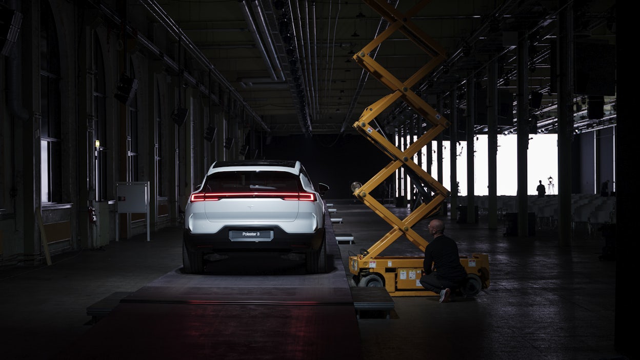 A white Polestar 3 in a warehouse.