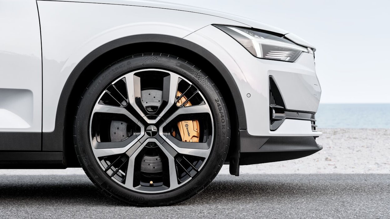 Side view of Polestar 2 hood and front wheel with golden breaks