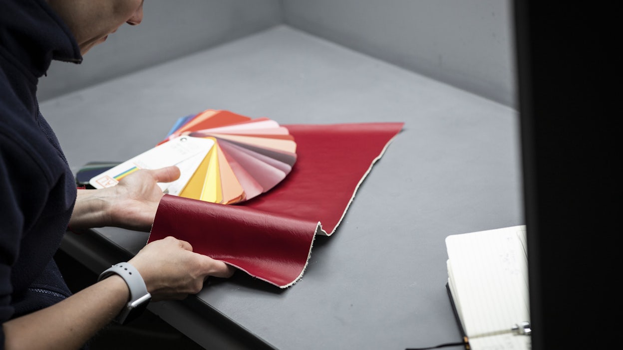 Woman inspecting leather samples at the Brigde of Weir factory.