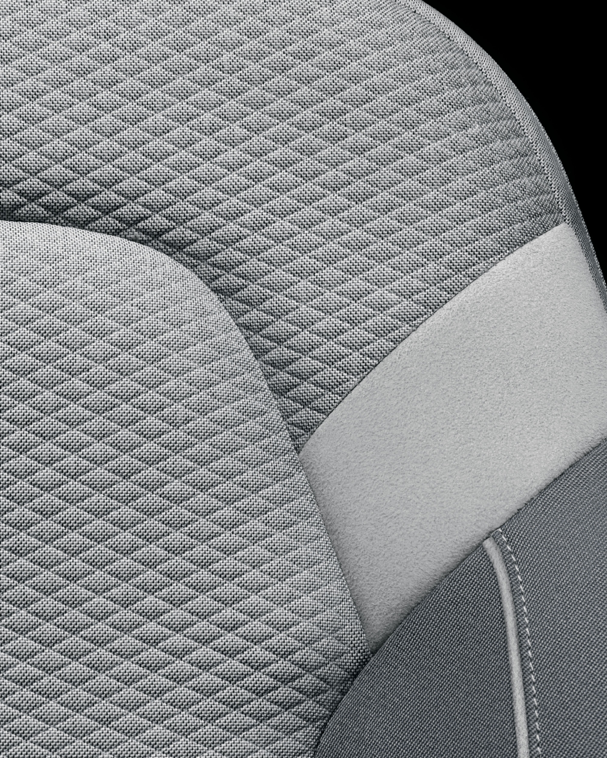 Close-up on the material for standard upholstery. Three shades of grey and patterns.