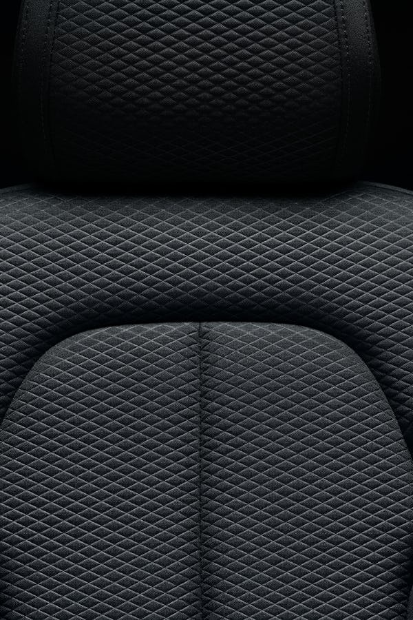 Close-up on dark upholstery and black background