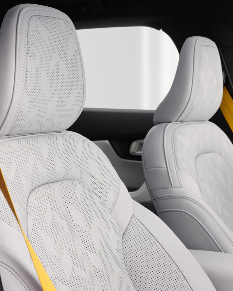 Light seats inside Polestar 2 with yellow/gold belts