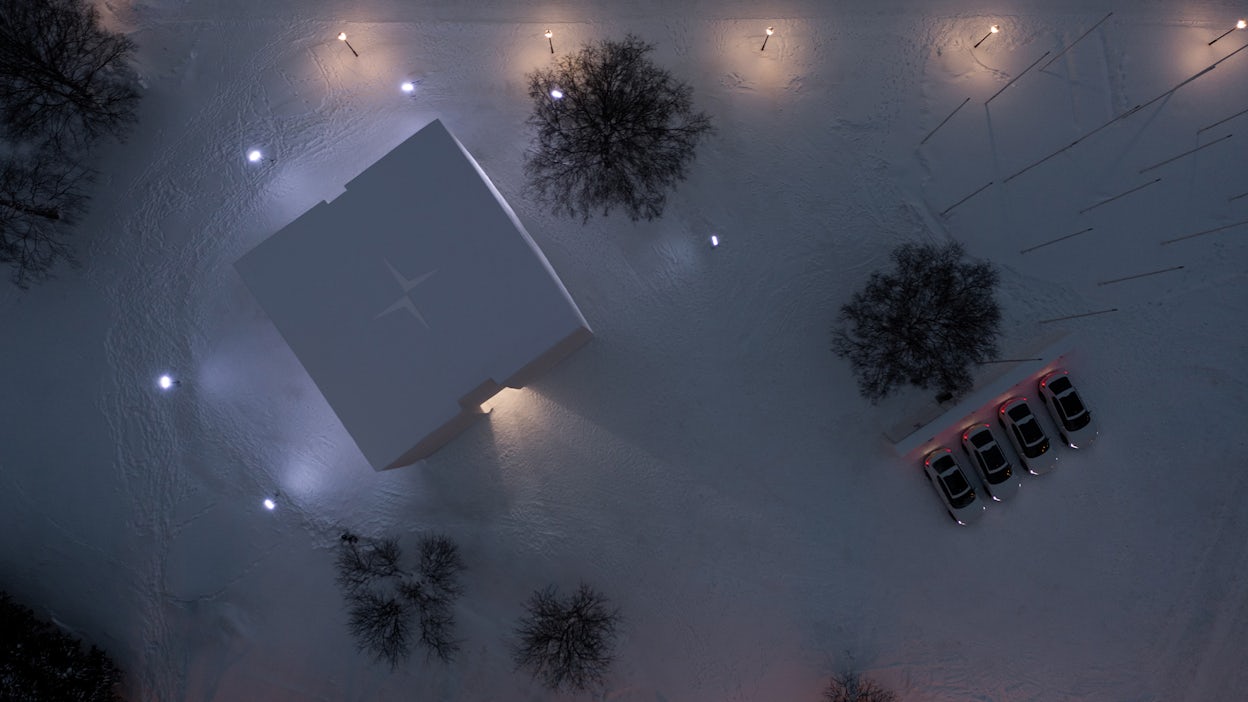 An overhead view of a building made of snow, with four Polestar cars nearby.
