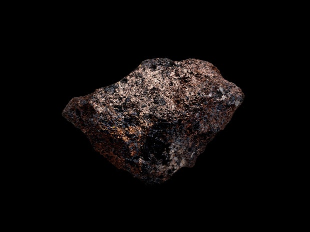 Goldenshimmering rock, black background.