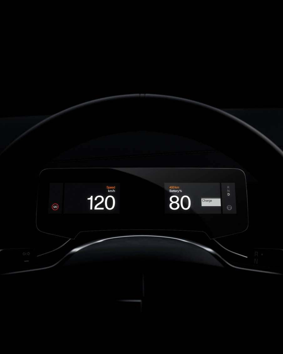 Behind the steering wheel, the screen shows the battery status data. The car brakes, adding energy back to the battery. The data is updated on the screen.
