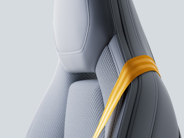 Side angled detail of Polestar 4 front seat backrest with Tailored knit upholstery and Swedish gold seatbelt