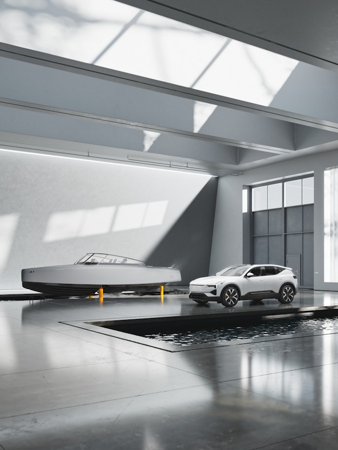 Grey Candela boat on golden foils  next to a white polestar 3 car