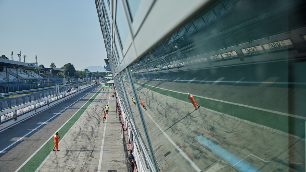 Racing staff walking on a motor racing track.