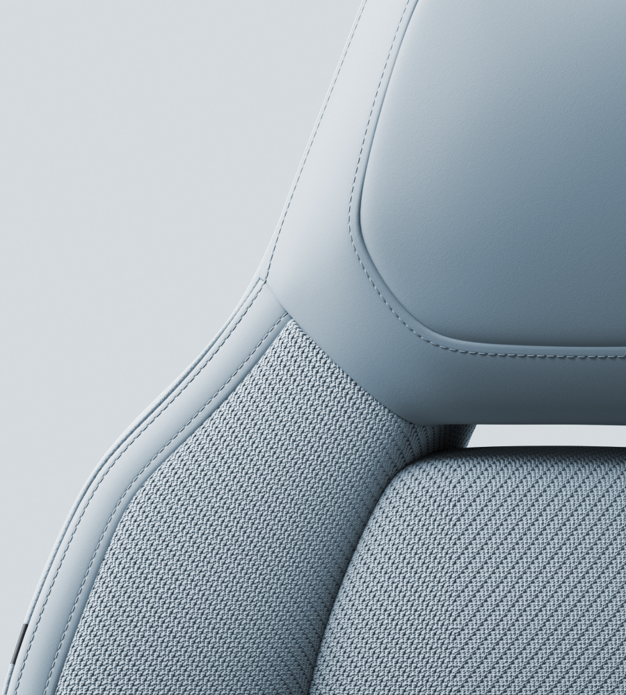 Headrest and upper part of a seat upholstered in gray/mist tailored knit fabric