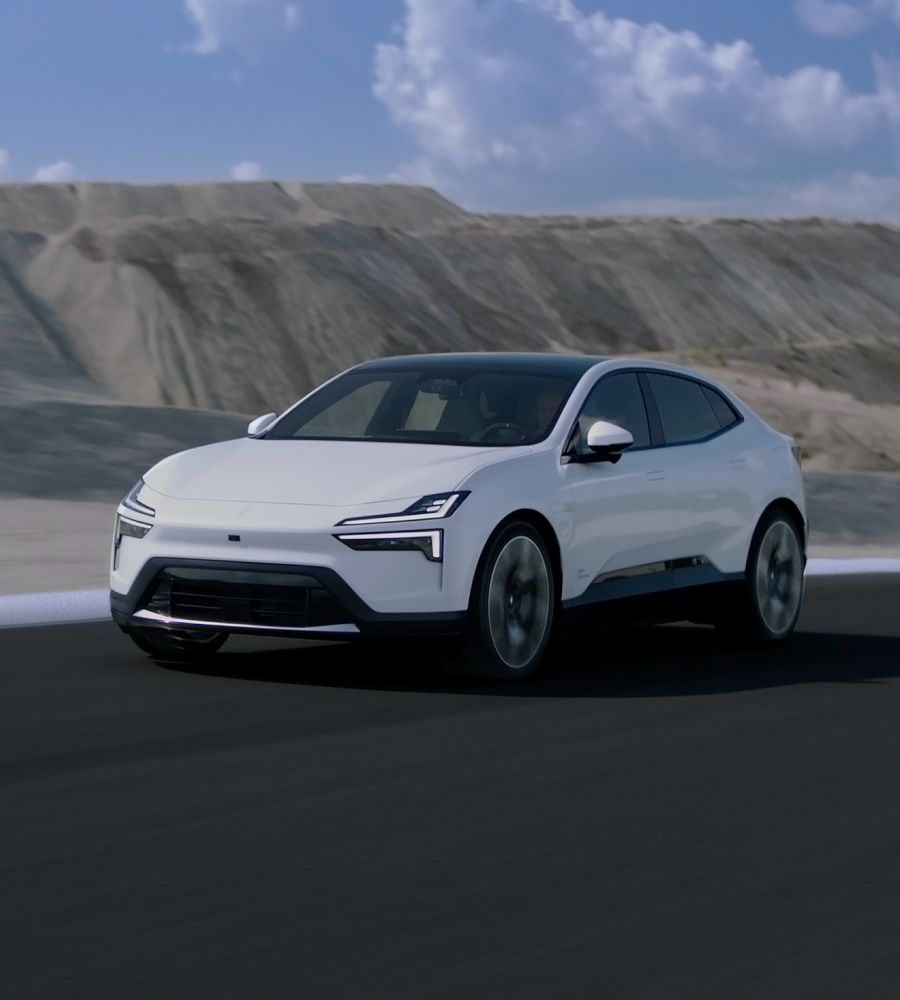 White Polestar 4 driving in a blurry landscape with mountains